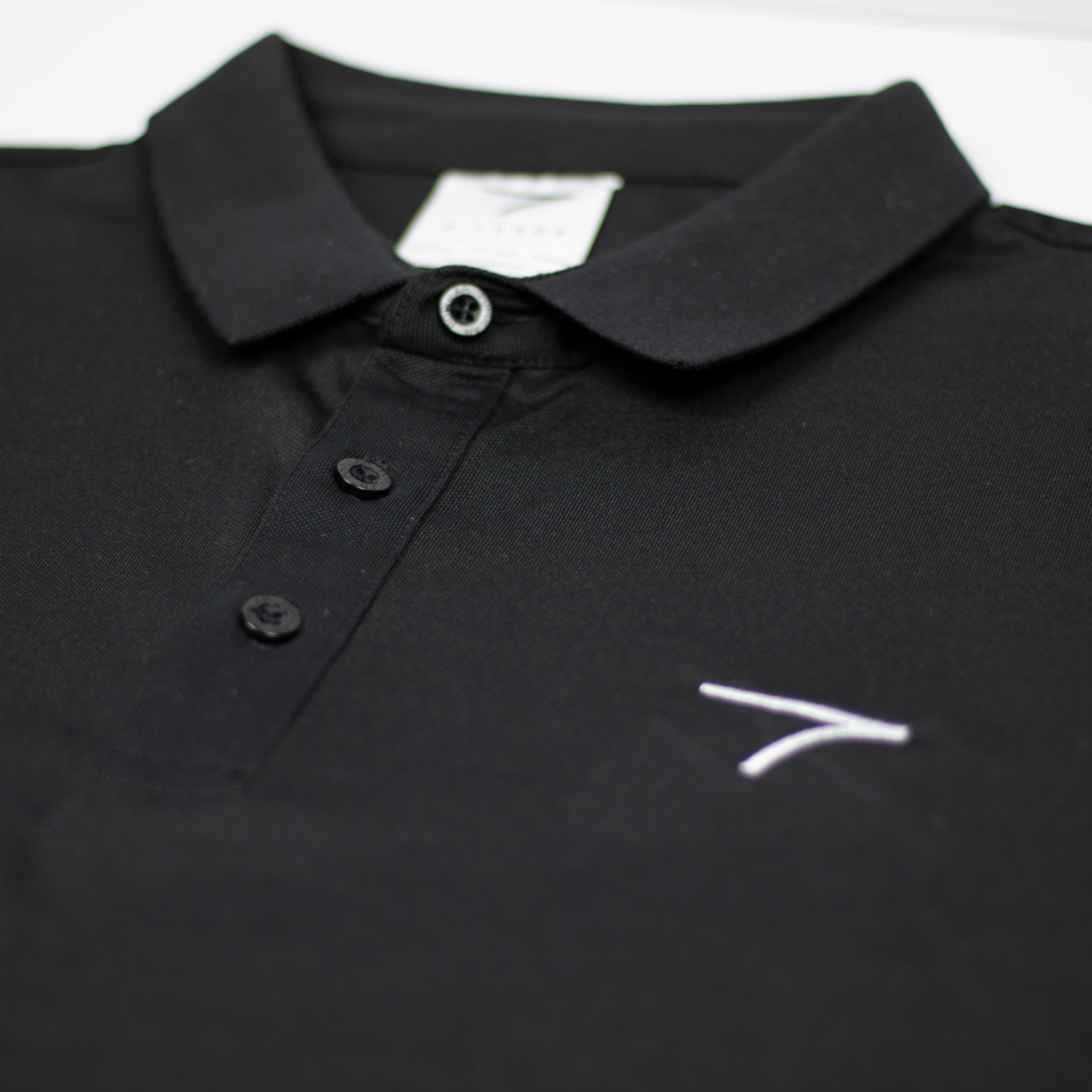 Close Up Black Polo Fable Logo on Golf Polo